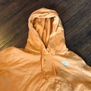 Orange women’s north face sweatshirt